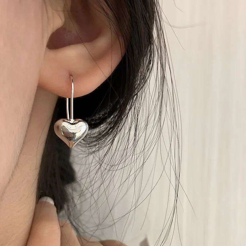 Korean-style glossy silver heart earrings with three-dimensional design and heart-shaped hooks