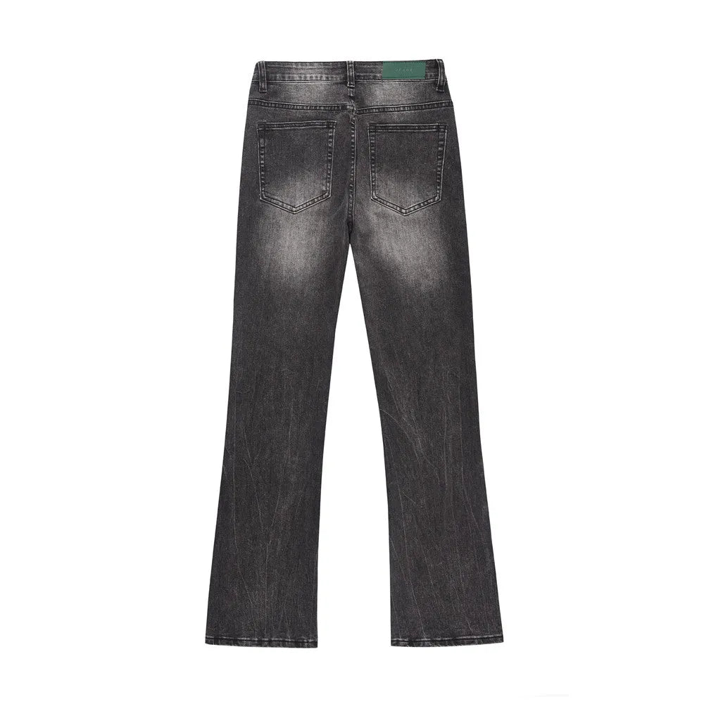 Men's black washed denim jeans on a flat surface showing full leg and pocket details