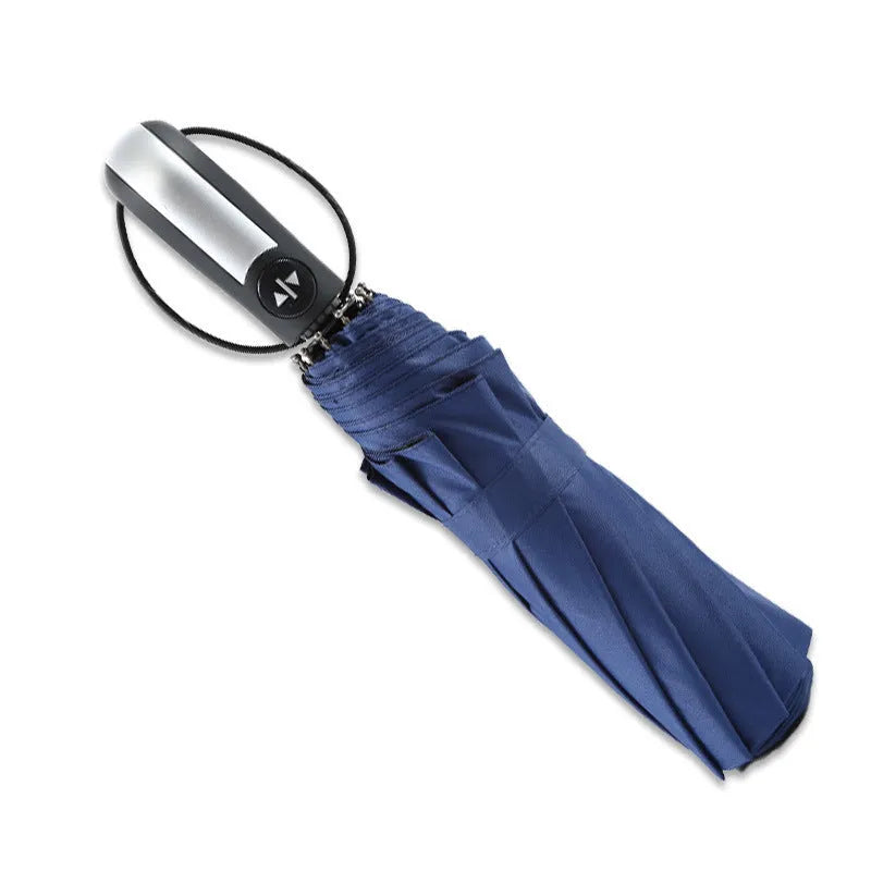 Automatic triple folding business umbrella in black, showing steel ribs and rubber handle.