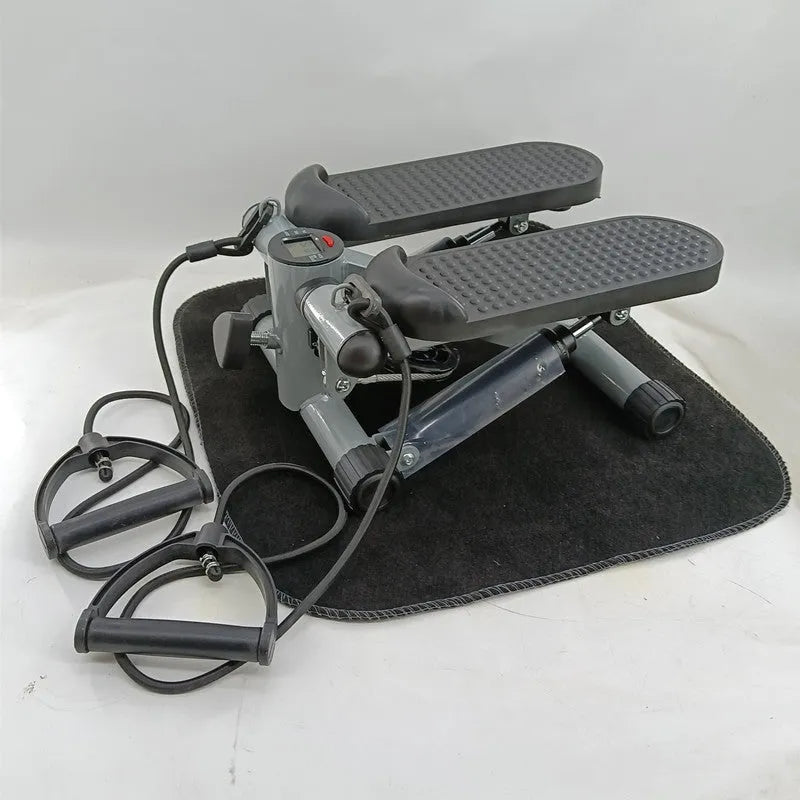 Silver grey hydraulic mini treadmill waist slimming pedal exercise machine for home use.