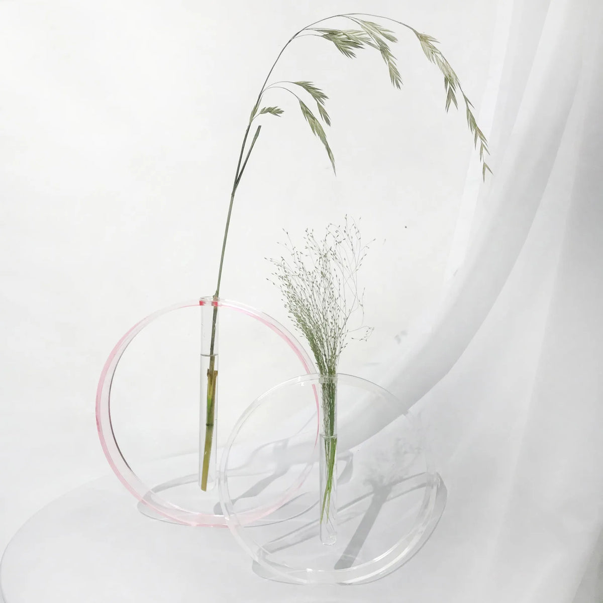 Handmade acrylic test tube vase with polished surface, shown in pink or transparent, small or large size options.