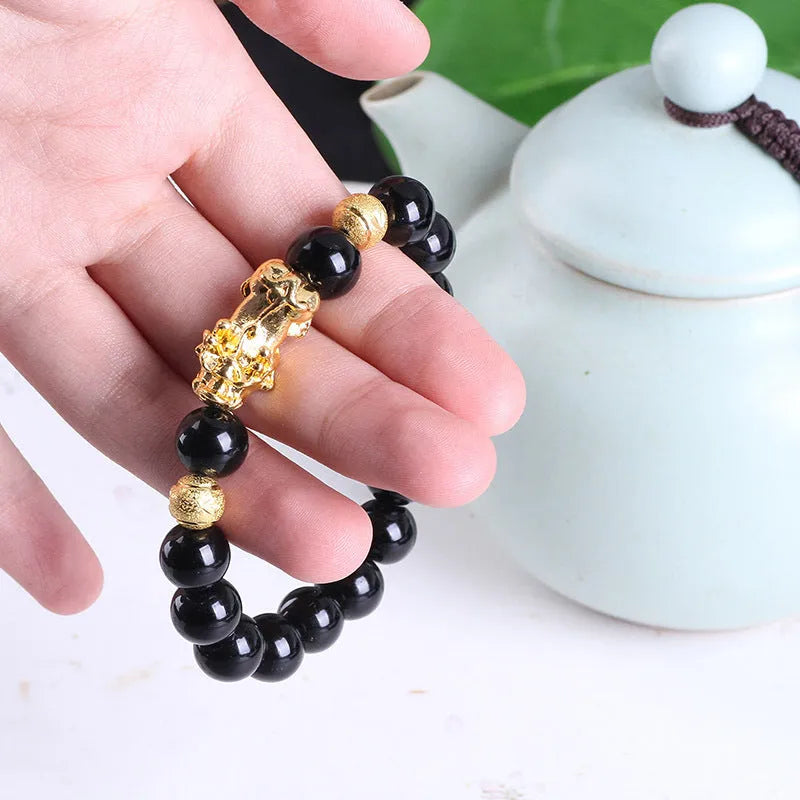 Imitation obsidian bracelet with 18K gold, little pearl and six brave words on hand