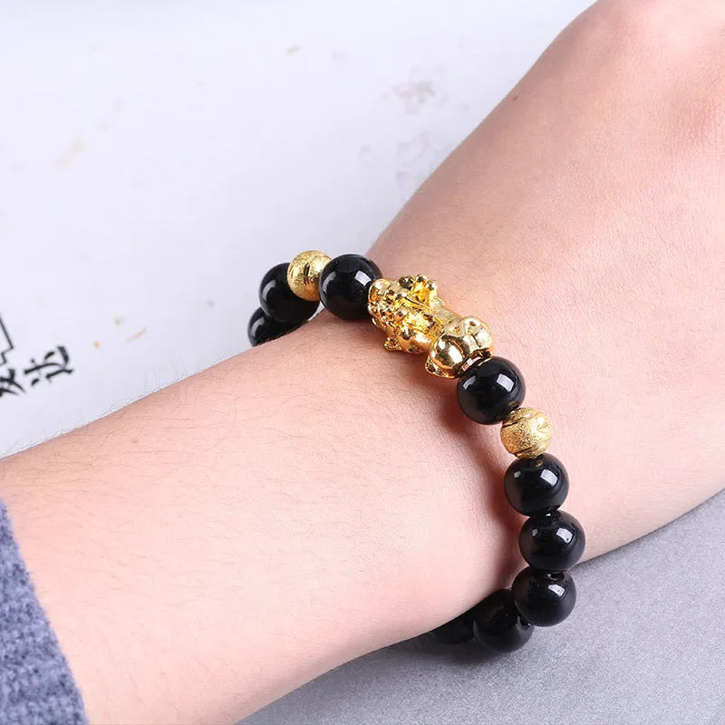 Imitation obsidian bracelet with 18K gold, little pearl and six brave words on hand
