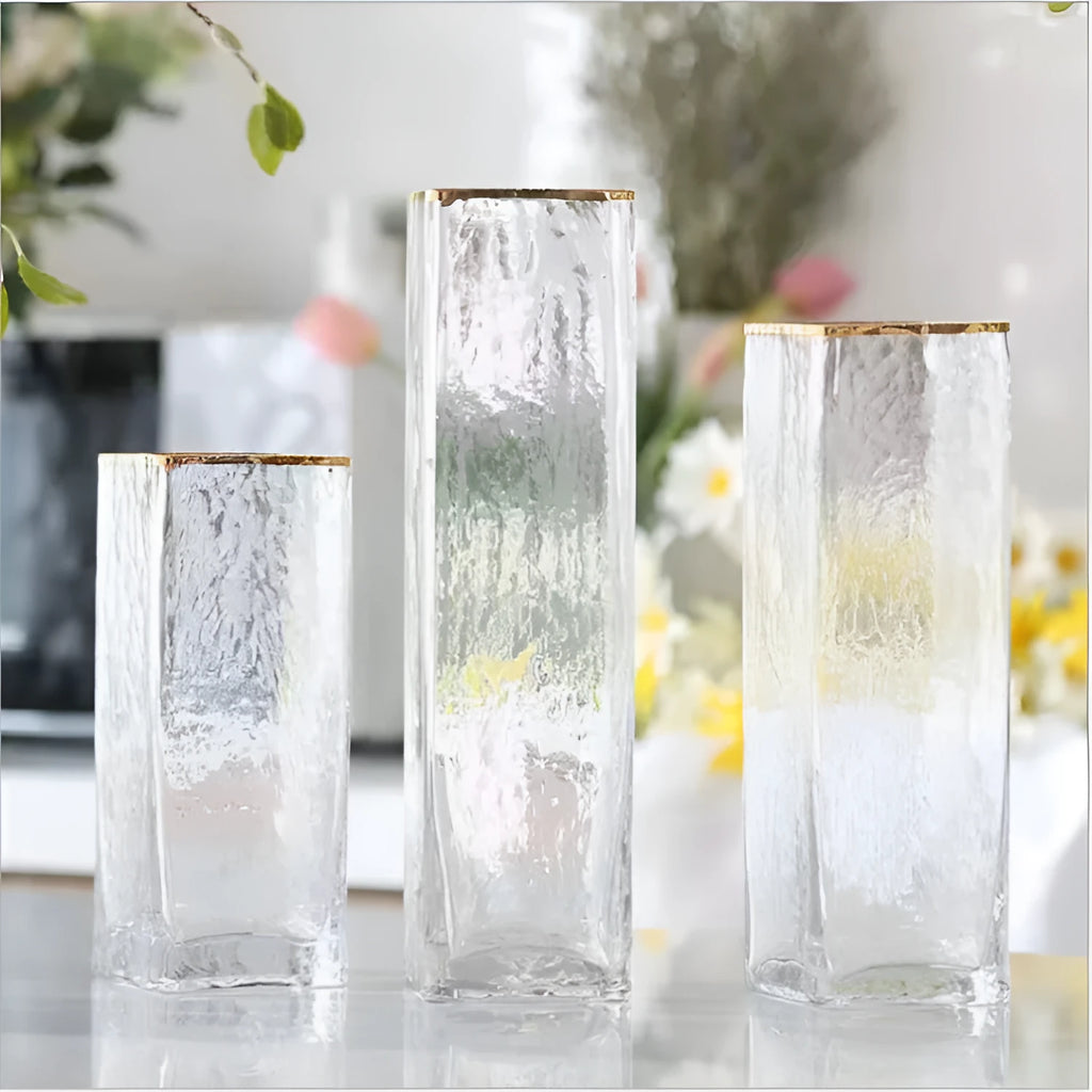 Transparent gold-painted glass vase on plain background