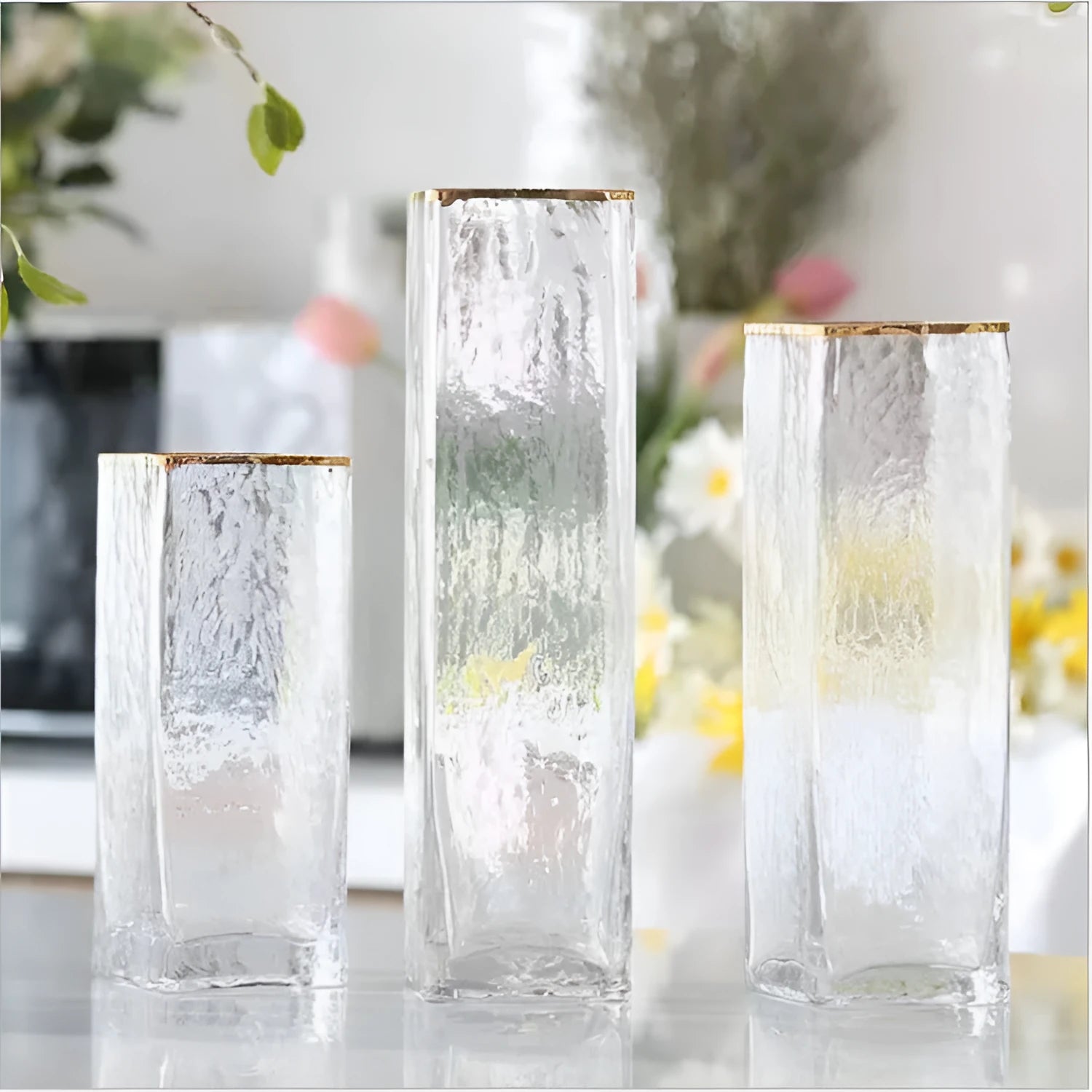 Transparent gold-painted glass vase on plain background