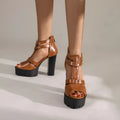 Women's black platform high heel sandals with a round toe and a back zipper fastening.