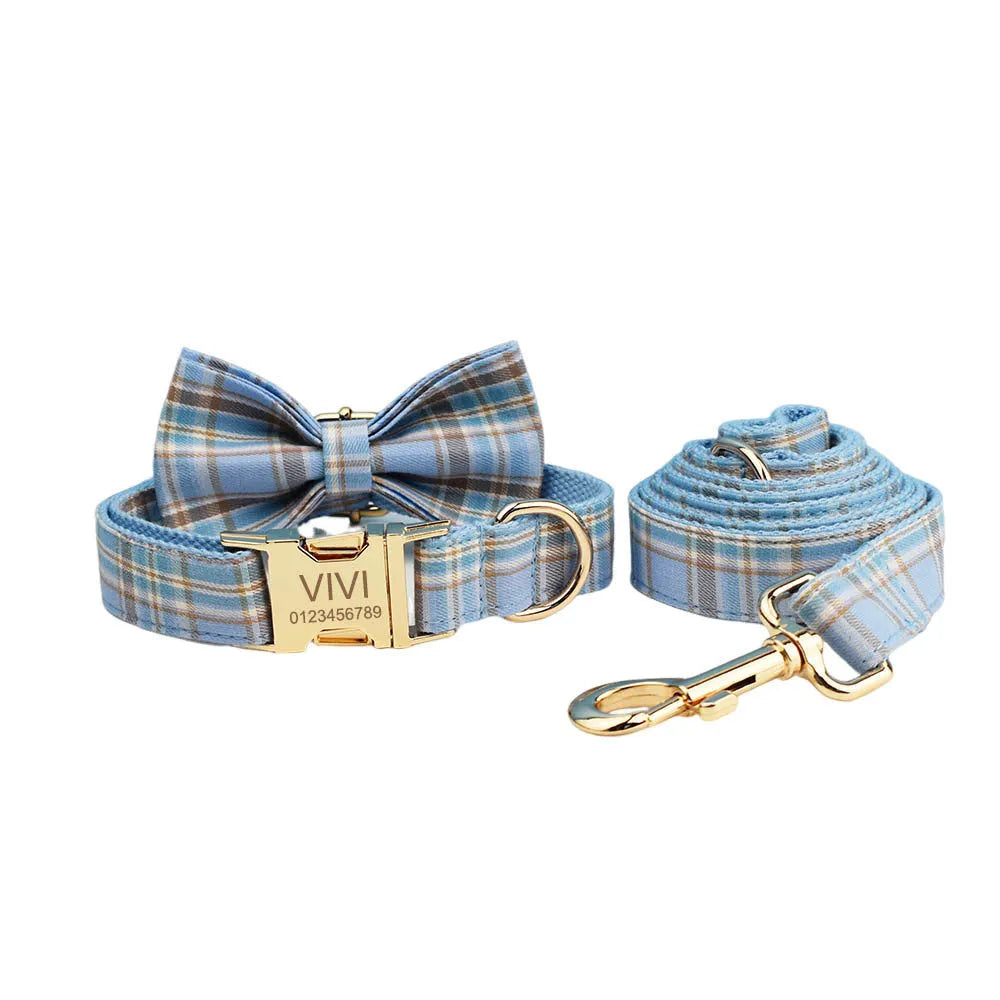 Sky blue grid forest pattern dog collar, leash, bow, and vest four-piece set on white background