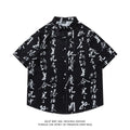 Man wearing a loose-fitting short sleeve printed shirt with a floral pattern, styled like a casual cardigan.