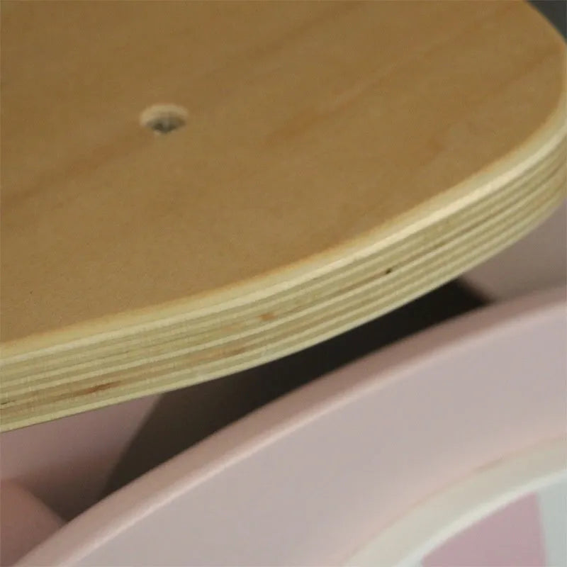 Pink wooden balance scooter for toddlers with a 10-inch non-slip deck.