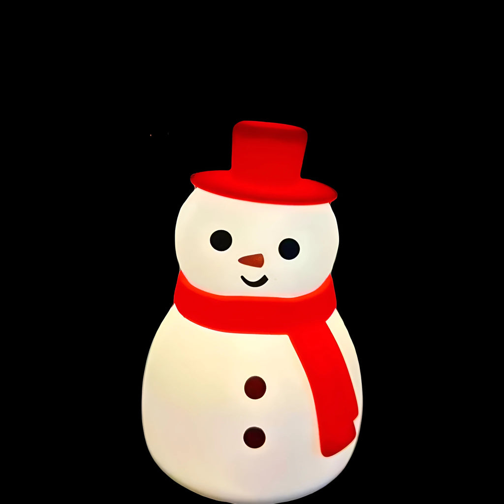 Cartoon snowman shaped silicone night lamp with warm light on a desk