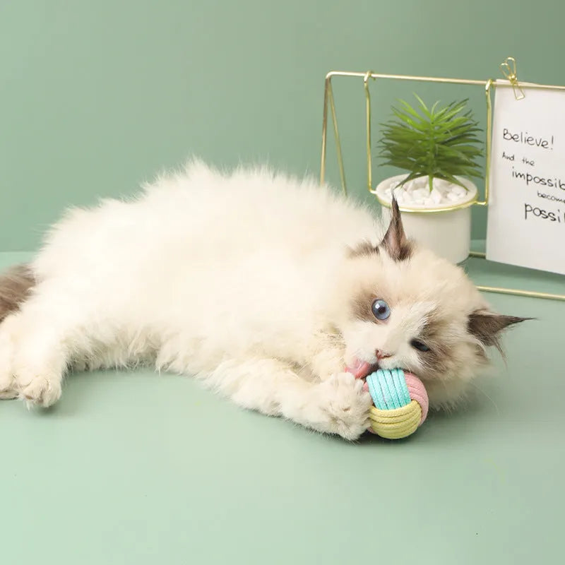 Handmade plush cotton cat hair ball toy in blue powder, green blue, or pink green colours measuring 5cm diameter
