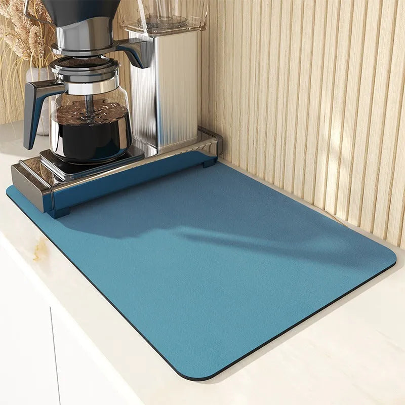 Black super absorbent rubber-backed kitchen drain mat on a countertop