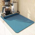 Black super absorbent rubber-backed kitchen drain mat on a countertop