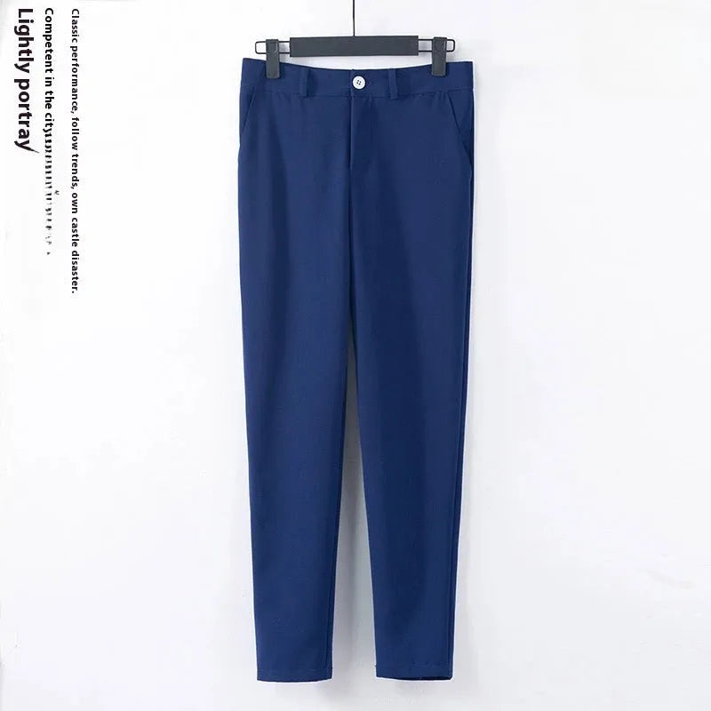 Blue polyester formal suit set with long sleeve jacket and cropped pants on a model
