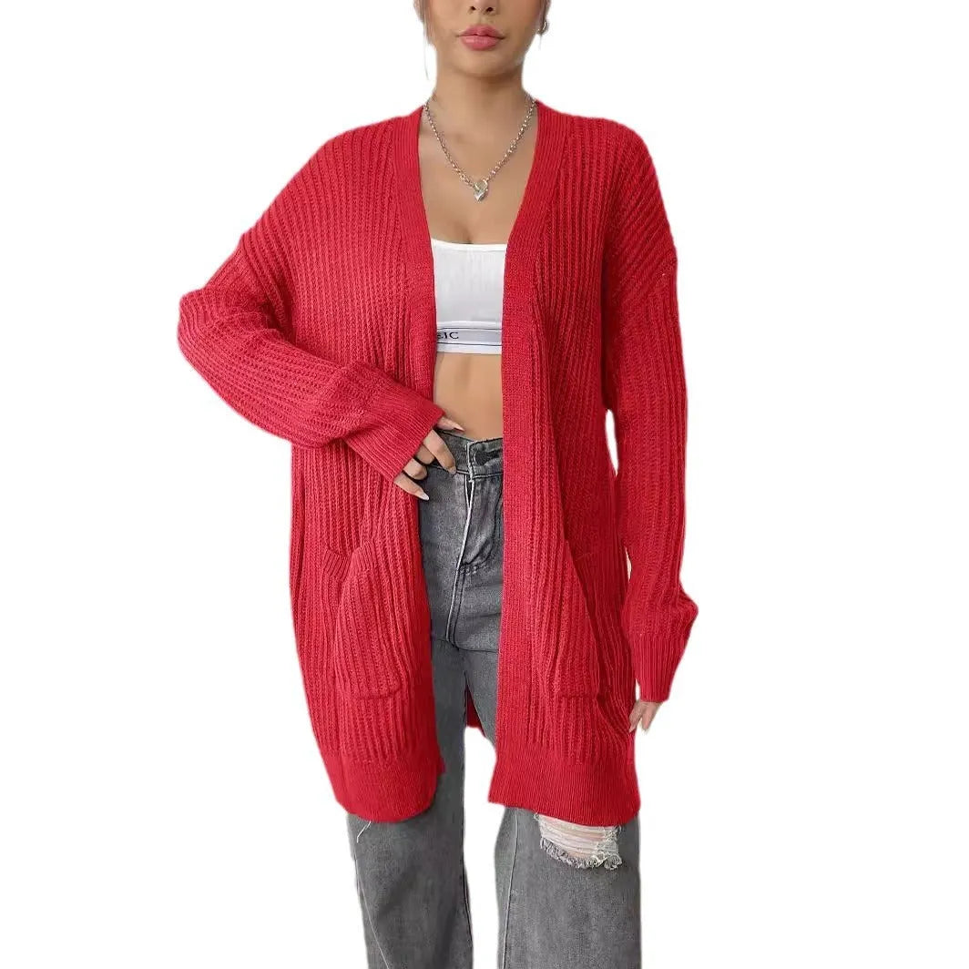 Women's dark green double pocket casual cardigan sweater laid flat.