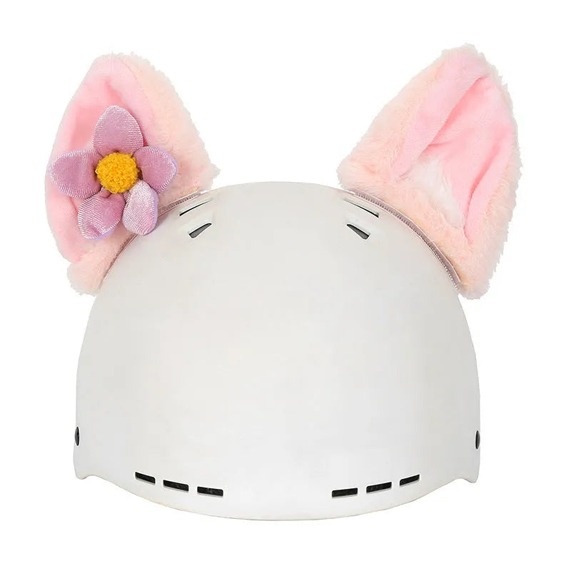 A plush fabric helmet cover with cartoon print and 3D ears, next to a matching beanie hat, on a neutral background.