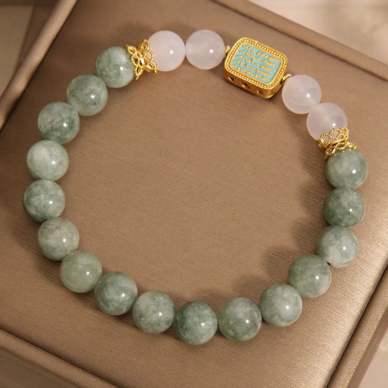 Women's oil green emerald crystal bracelet with five natural gemstones on a wrist.