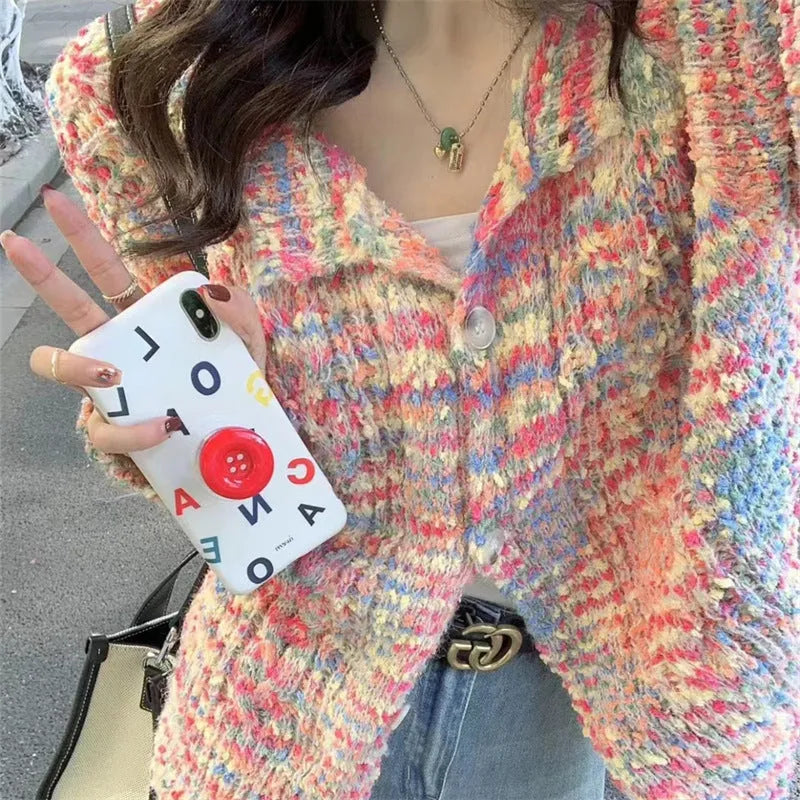 Pink and green rainbow pattern knitted cardigan on a hanger, showing slim fit and regular sleeves.