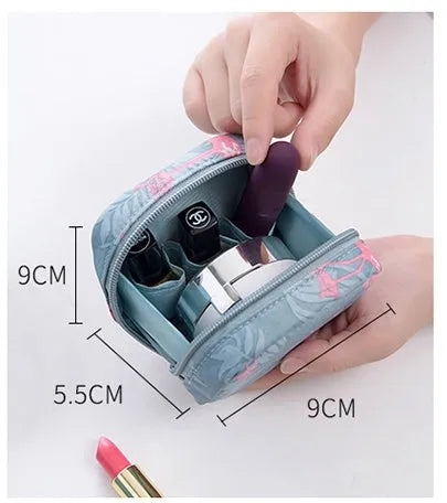 Blue cloth cube-shaped makeup storage bag with plain pattern, open to show interior space.
