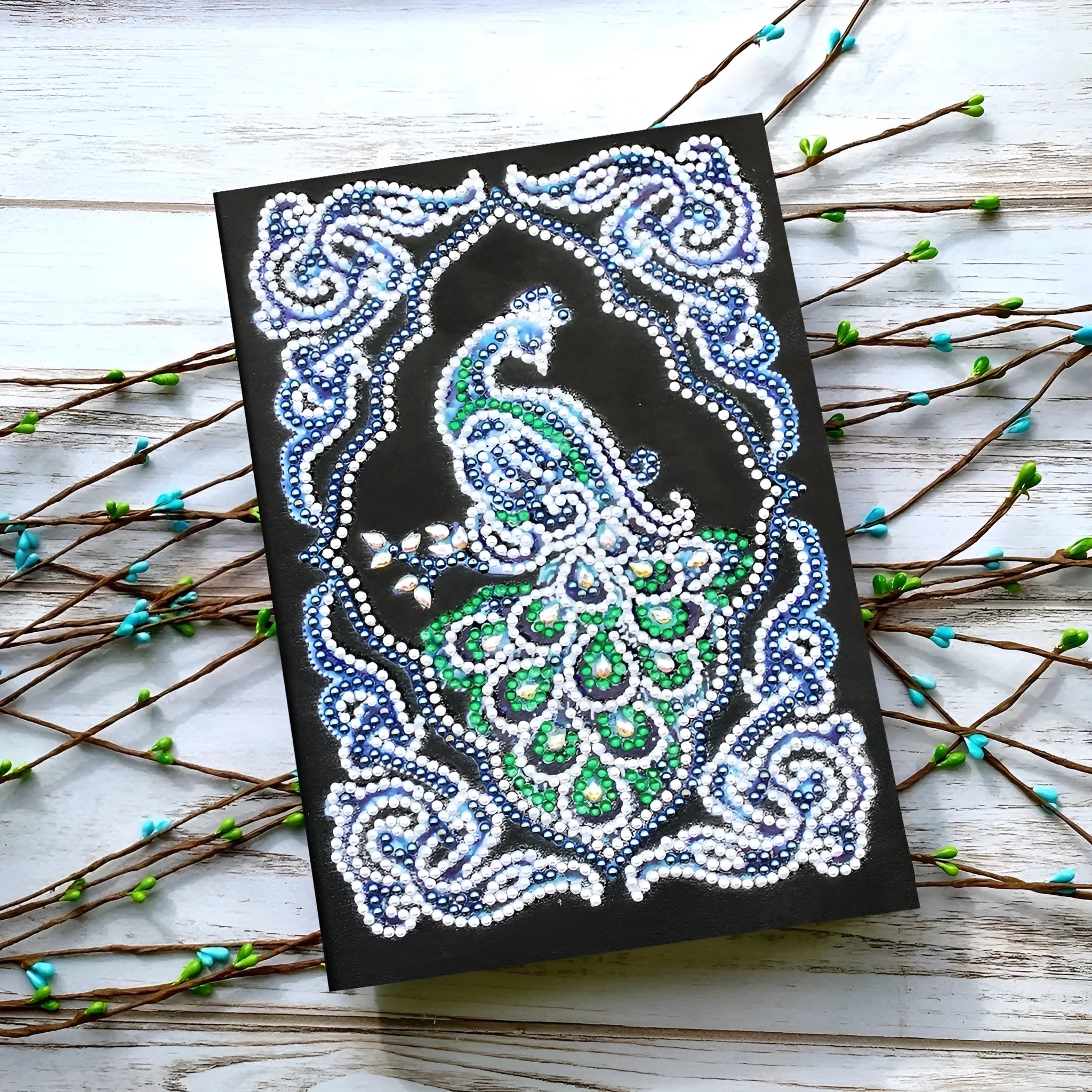 Peacock Beauty A5 diamond painting journal with black cover, shaped and bright drills, showing 142x207mm dimensions.