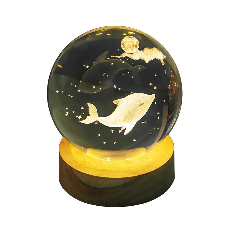 Transparent crystal ball night lamp with 3D carved jellyfish design, on a round base with USB cable.