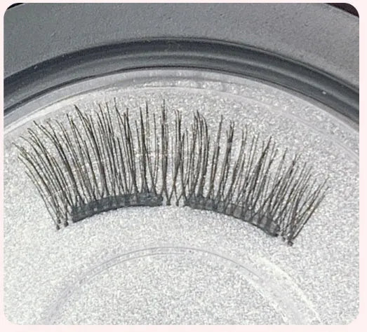 Magnetic false eyelash set with soft and hard lashes, magnetic iron clip, and eyelash curler on white background