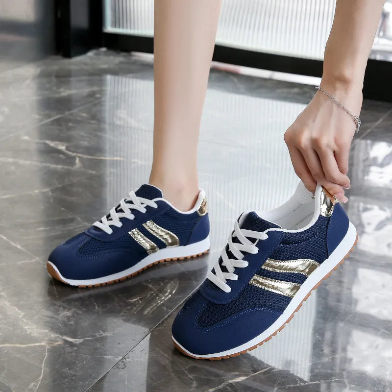 Blue women's casual sports shoes with cross shoulder straps and a white rubber sole.