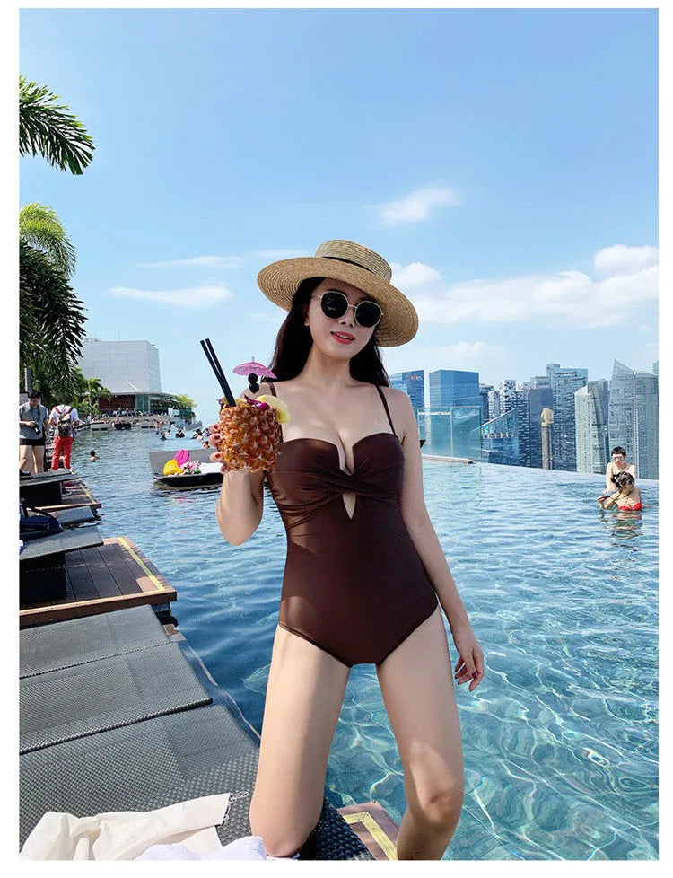 Women's solid colour one-piece swimsuit with push-up design and spaghetti straps in polyester