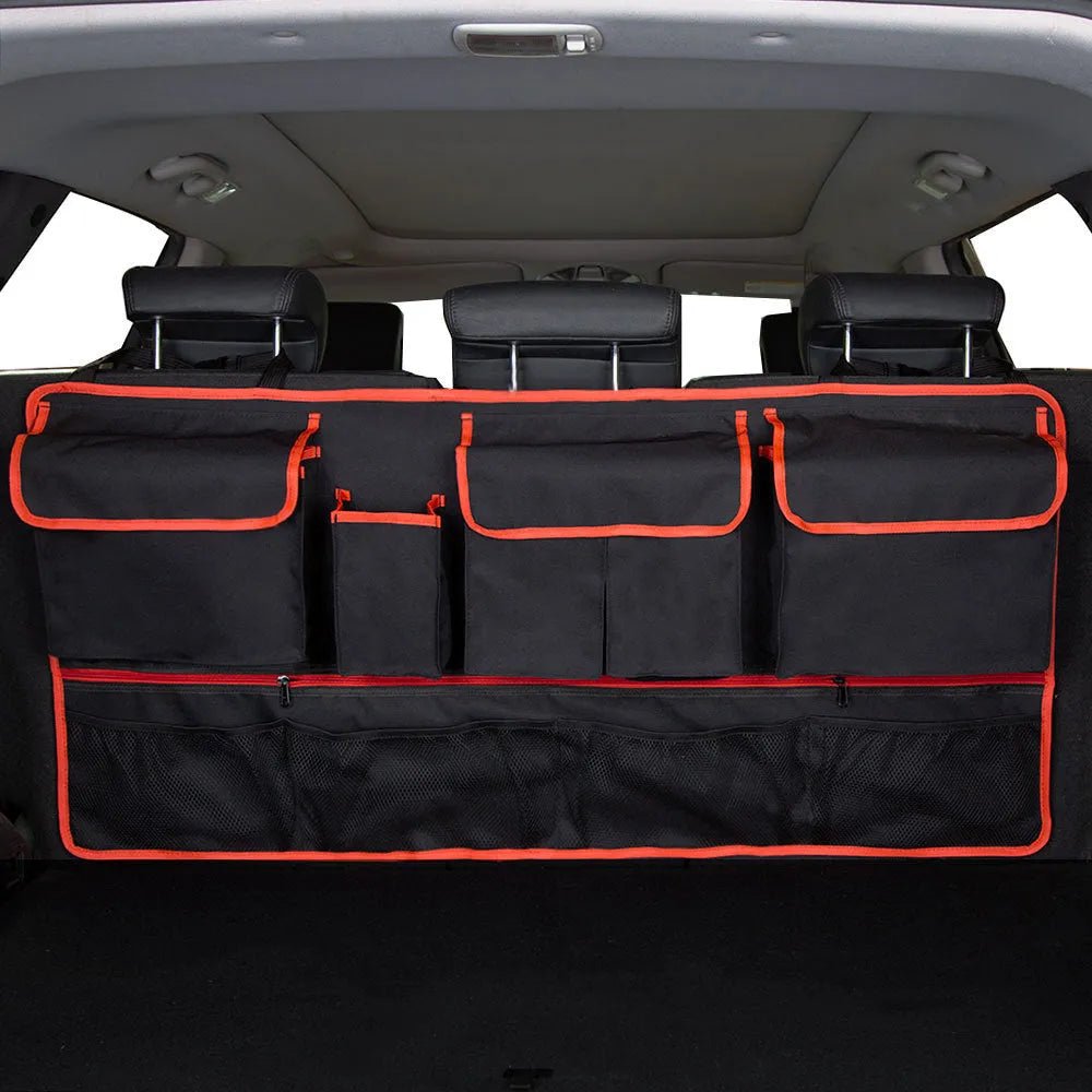Car trunk hanging storage shopping bag in black with red piping, showing Oxford cloth construction and reinforced handle