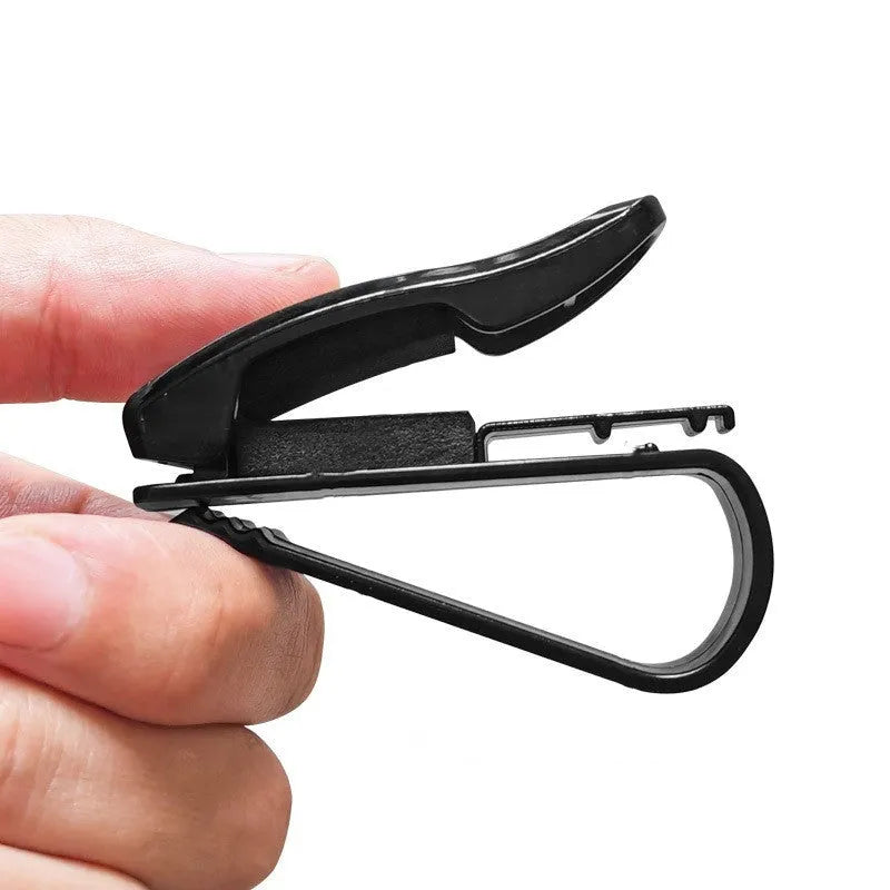 Black plastic car sunshade clip holder for glasses frames and cards measuring 6.5 by 2.3 centimetres