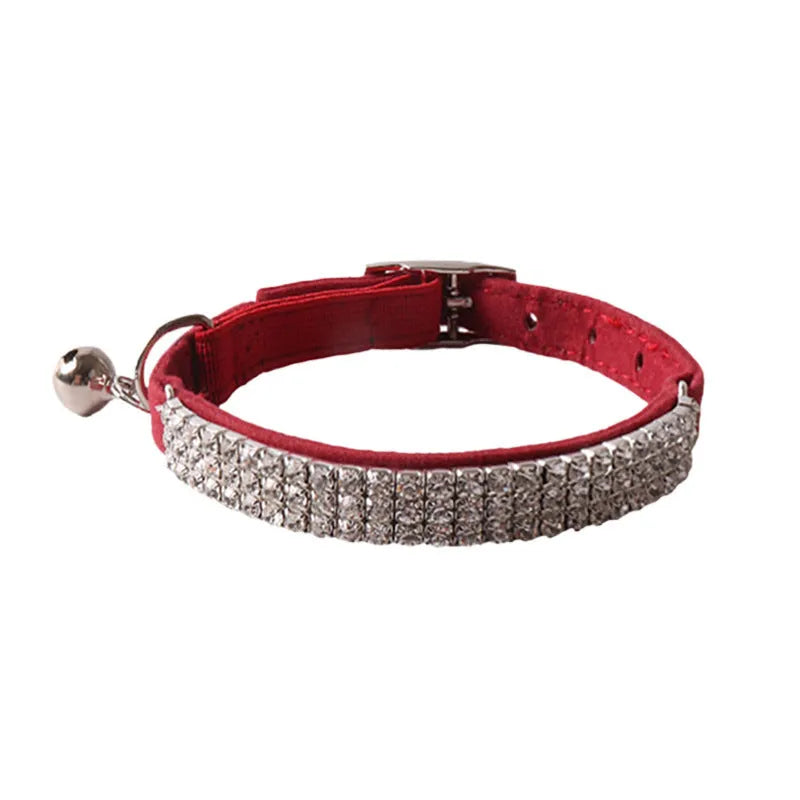 Soft flocked cat collar with elastic buckle in multiple colours on a white background.