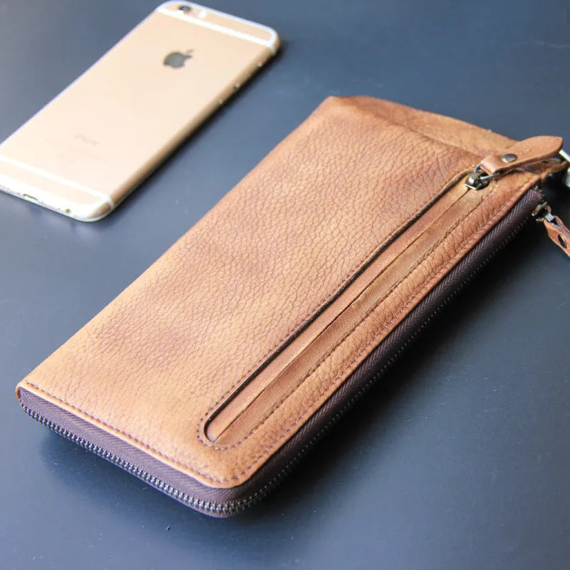 Retro long cowhide wallet with 13 card slots, zipper bill pocket, in bark brown, on flat surface