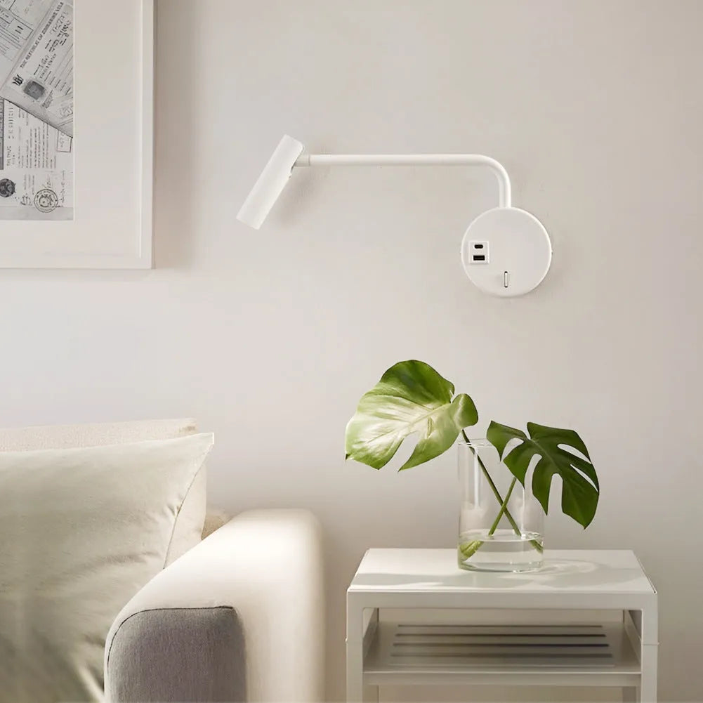 Rocker LED reading wall lamp in black finish with adjustable arm and head for bedside use
