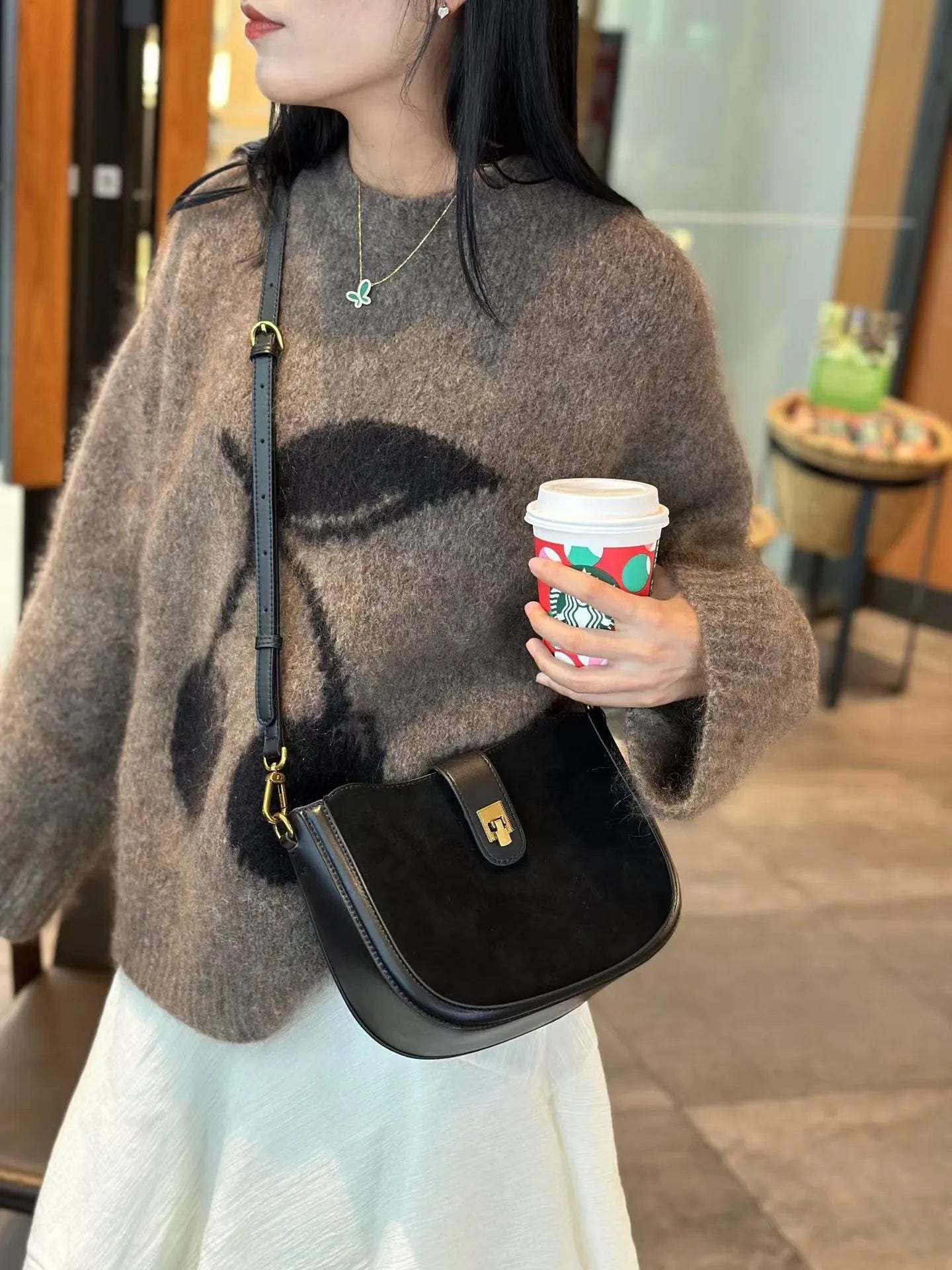 Women's black genuine leather crossbody bag with one-shoulder design and sandwich pocket exterior