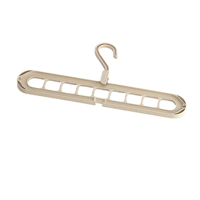 Green nine-hole plastic folding trousers hanger showing garment organisation