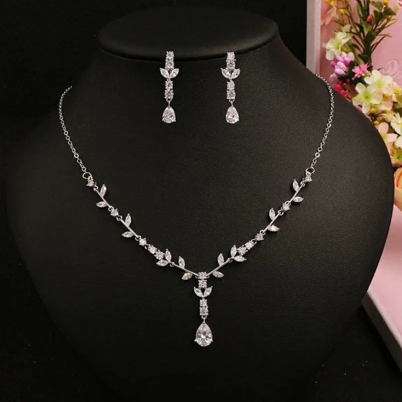 Simple bridal silver alloy love pattern necklace and earrings suite on display, handmade ornament set with ear clip option
