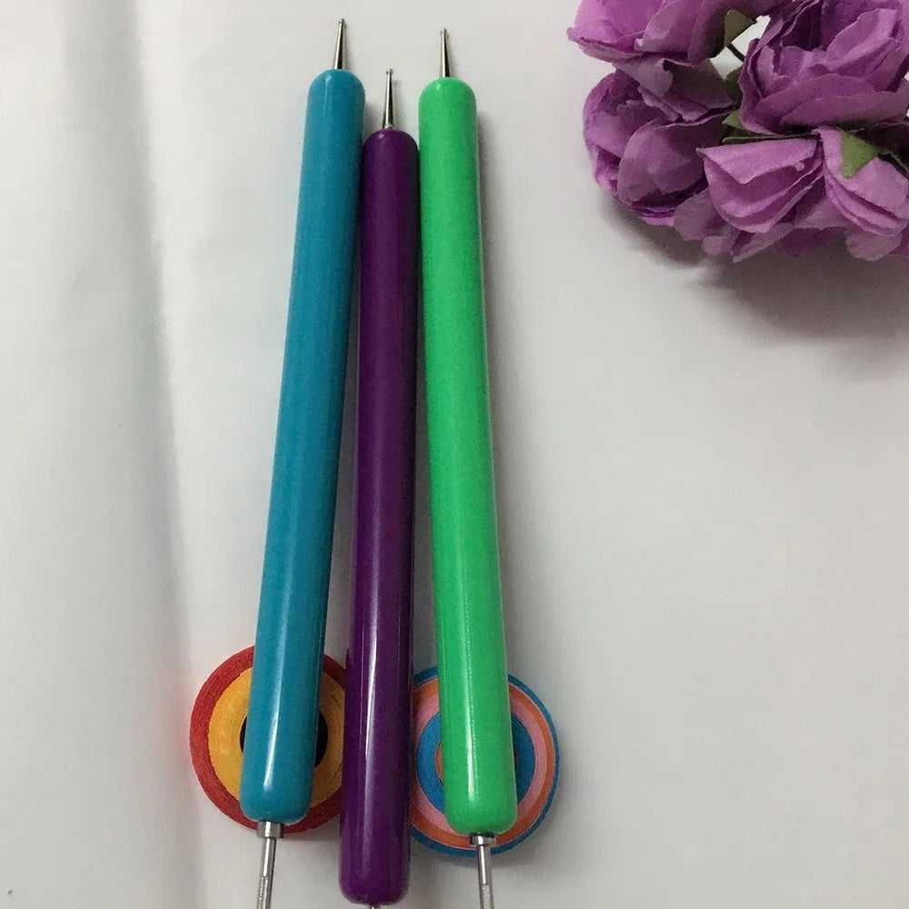 Purple quilling paper tool set with five slotted pens and needle stylus on white background