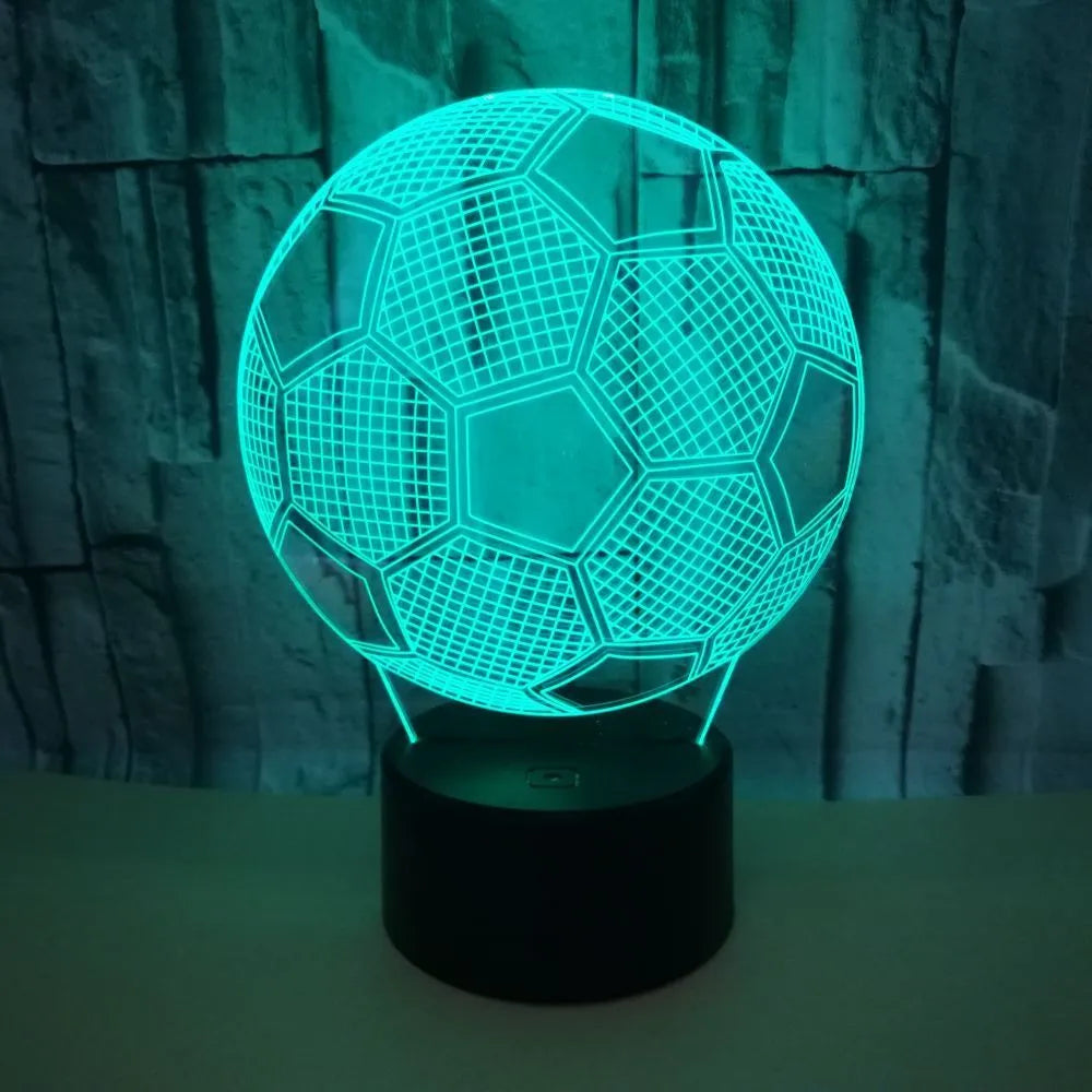 3D football-shaped LED night light on a black base showing multi-colour gradient illumination.