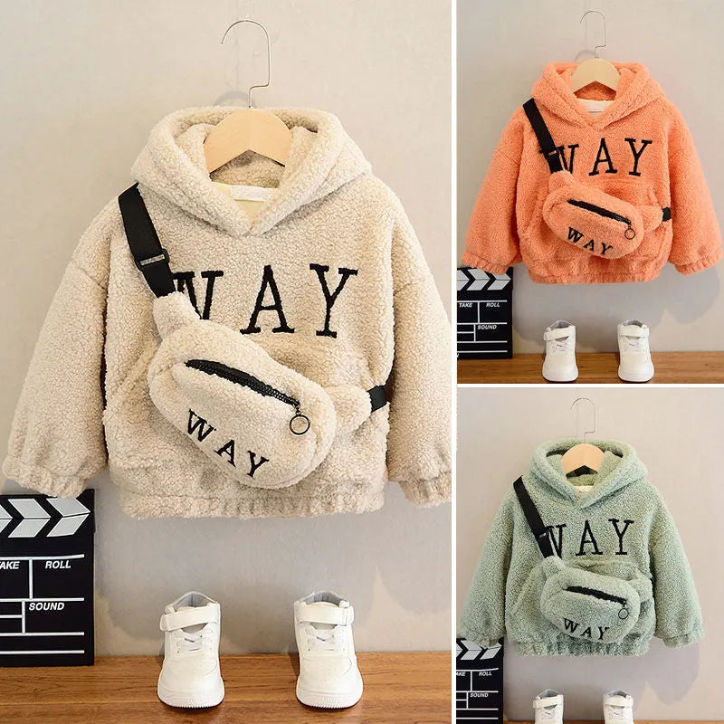 Child wearing a beige cashmere fleece hooded jacket with a cartoon pattern on the front.
