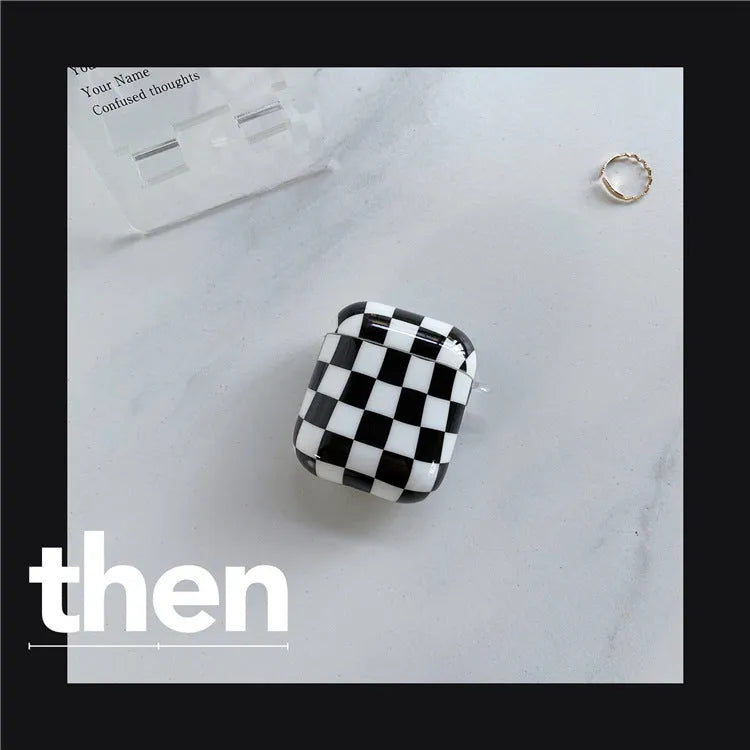 Black and green checkerboard pattern TPU protective case sleeves for Apple AirPods, one with a smiley face lanyard attached.