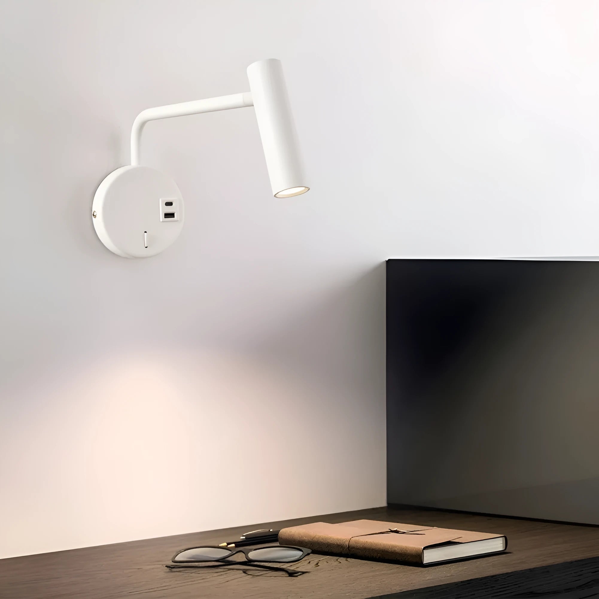 Rocker LED reading wall lamp in black finish with adjustable arm and head for bedside use