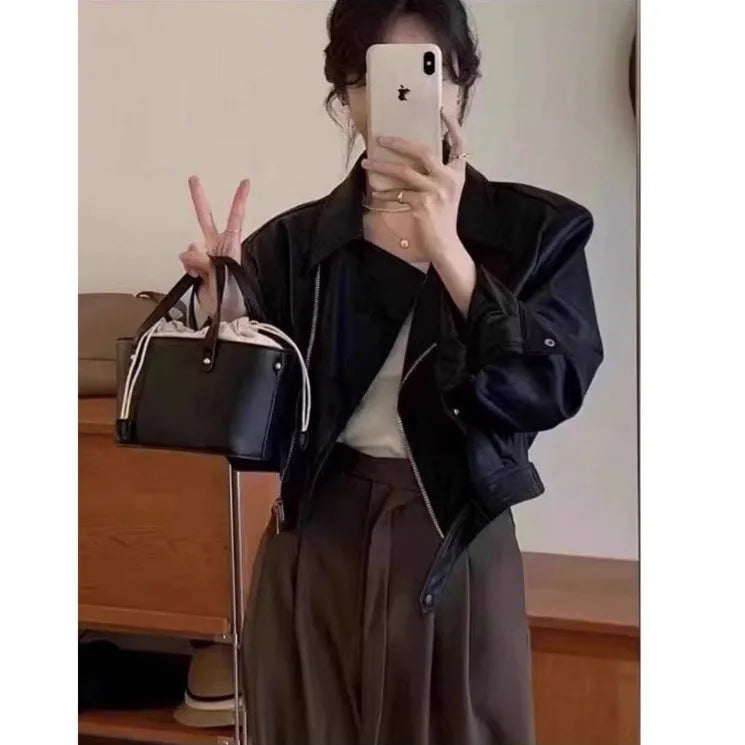 Brown women's retro slim-fit imitation leather jacket with pockets on a model.
