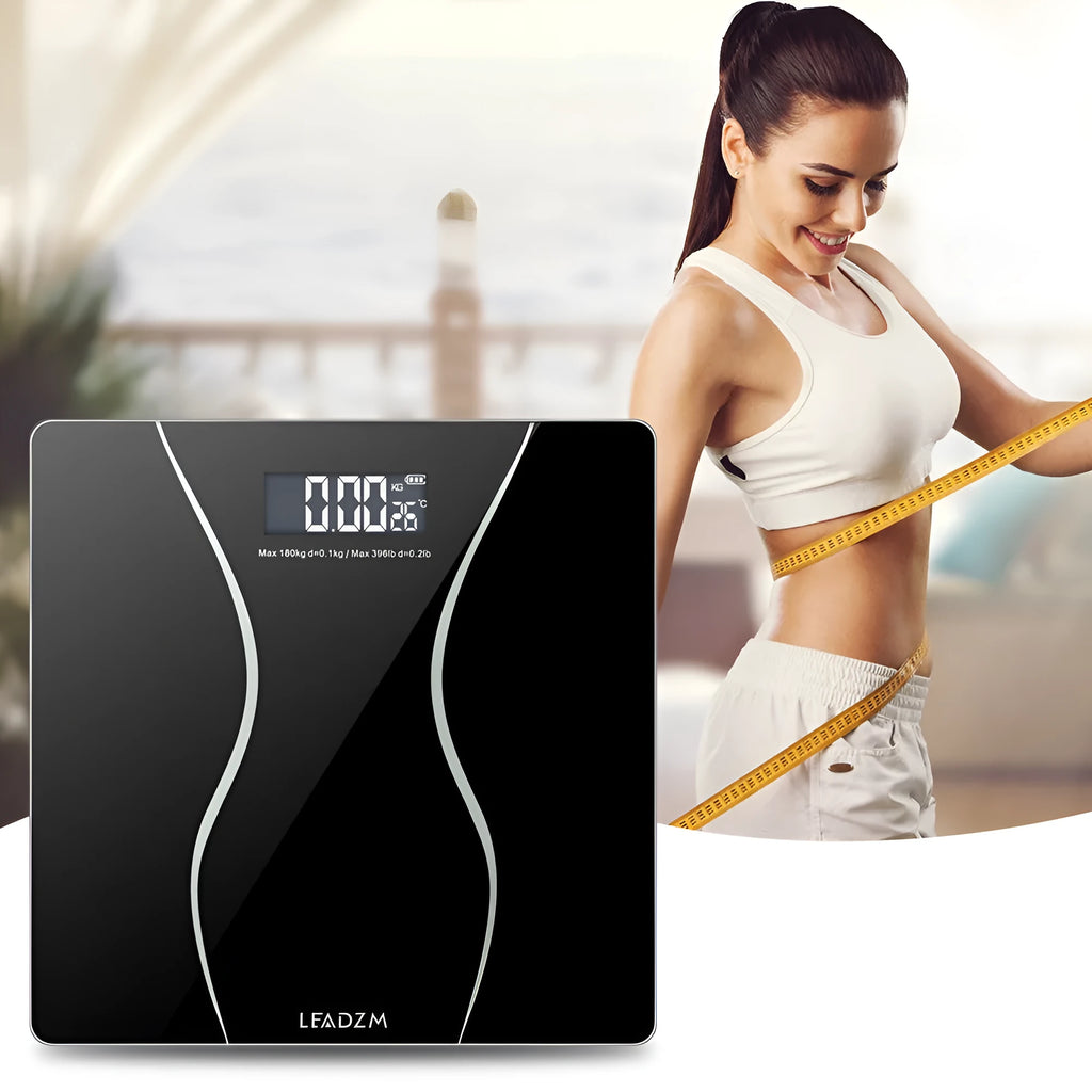 Black digital electronic bathroom scale on a tiled floor, showing digital display.