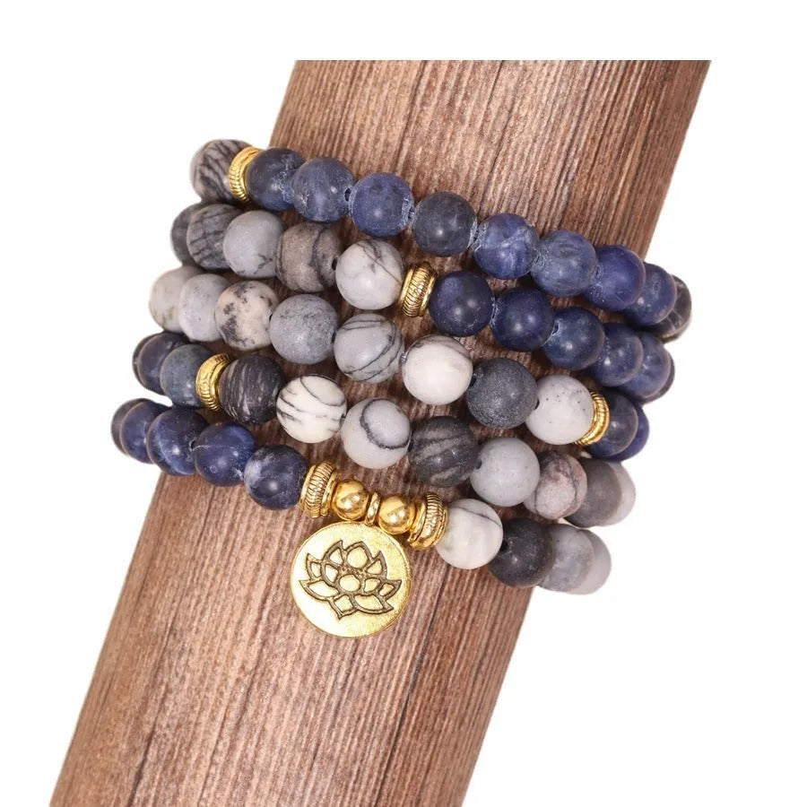 Blue multi-layer bracelet with patterned network stone beads and alloy components.