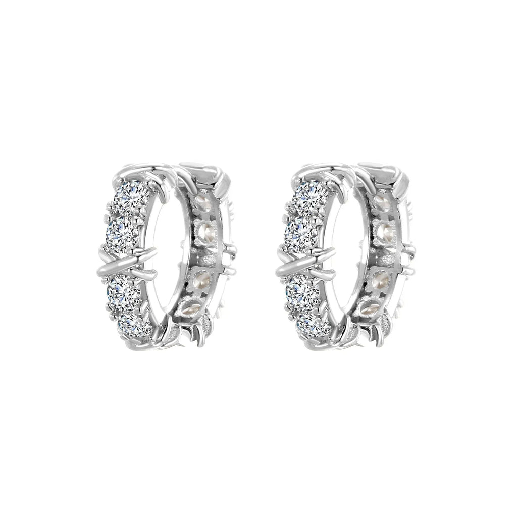 A pair of women's geometric hexagonal clover cross earrings in an electroplated silver or gold finish.