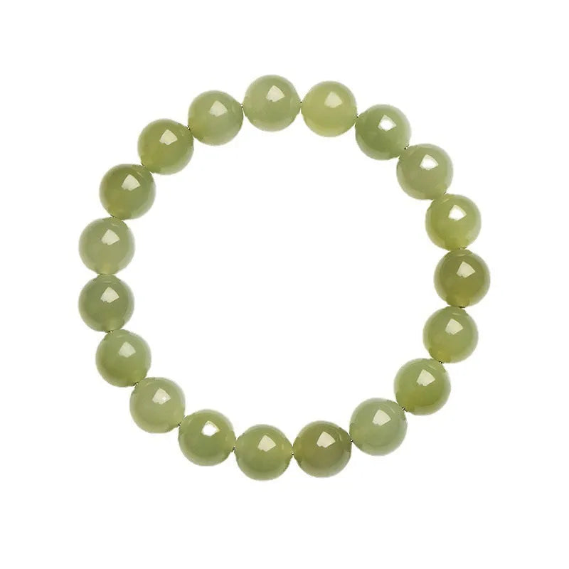 Polished Hetian jade ball bracelet on a wrist, showing spherical beads in a clear, ice-like colour.