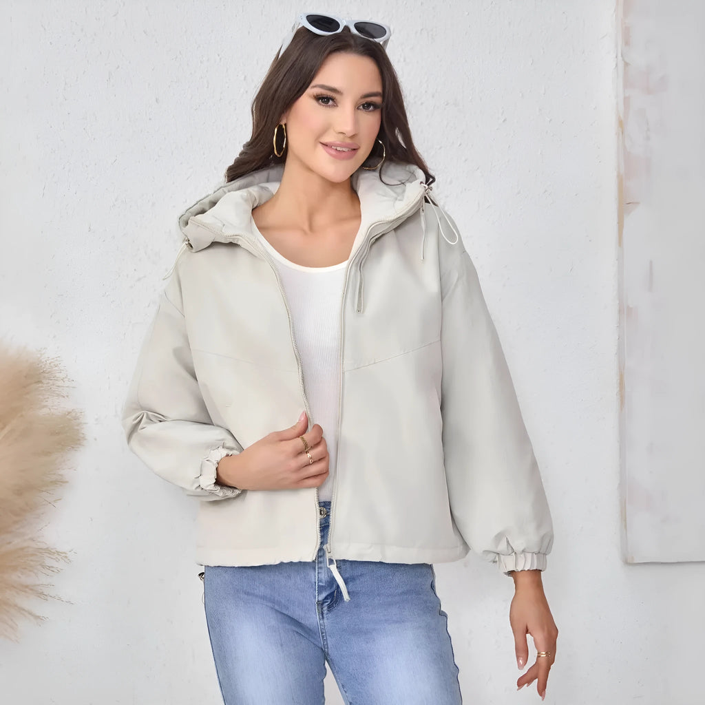 Women's loose fit hooded shell jacket in polyester, shown in grey, black, or purple.