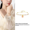 Pink women's bracelet with 925 silver cherry blossom pendant, Hetian jade beads, and gradient epoxy details.