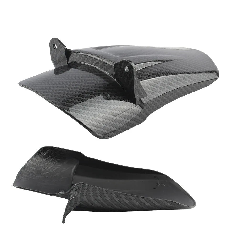 Carbon fibre rear shock absorber fender for a light bee scrambling motorcycle.