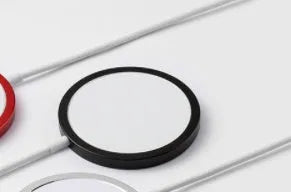 Silver metal MagSafe wireless charger with strong magnets for iPhone 12 and 13 models.